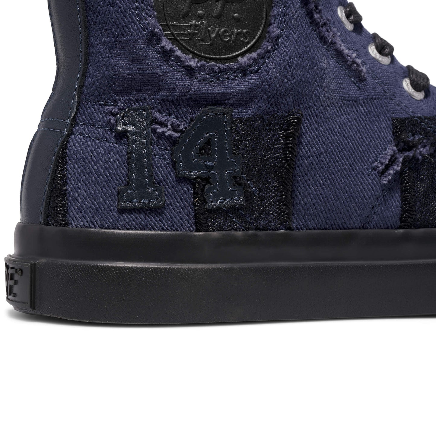 Close-up of a navy blue high-top sneaker with the number 14 on a white background