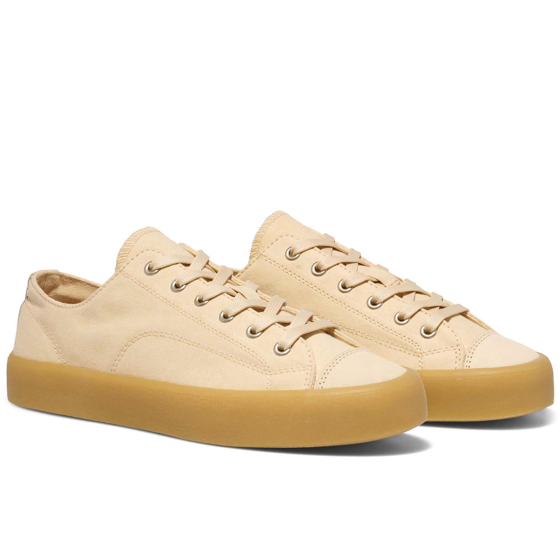 Beige low-top sneakers with tan soles on a white background.