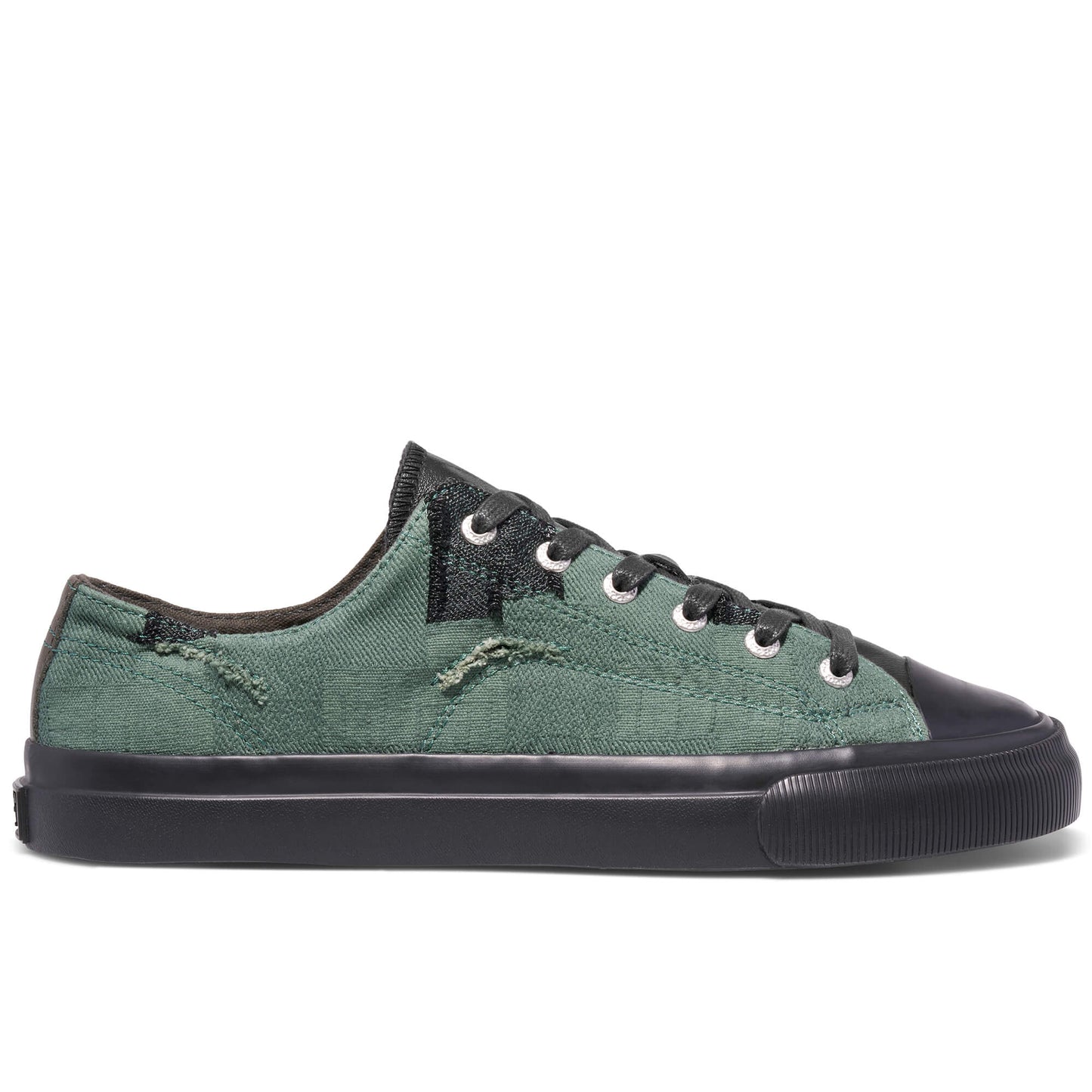 Green sneaker with black accents on a white background