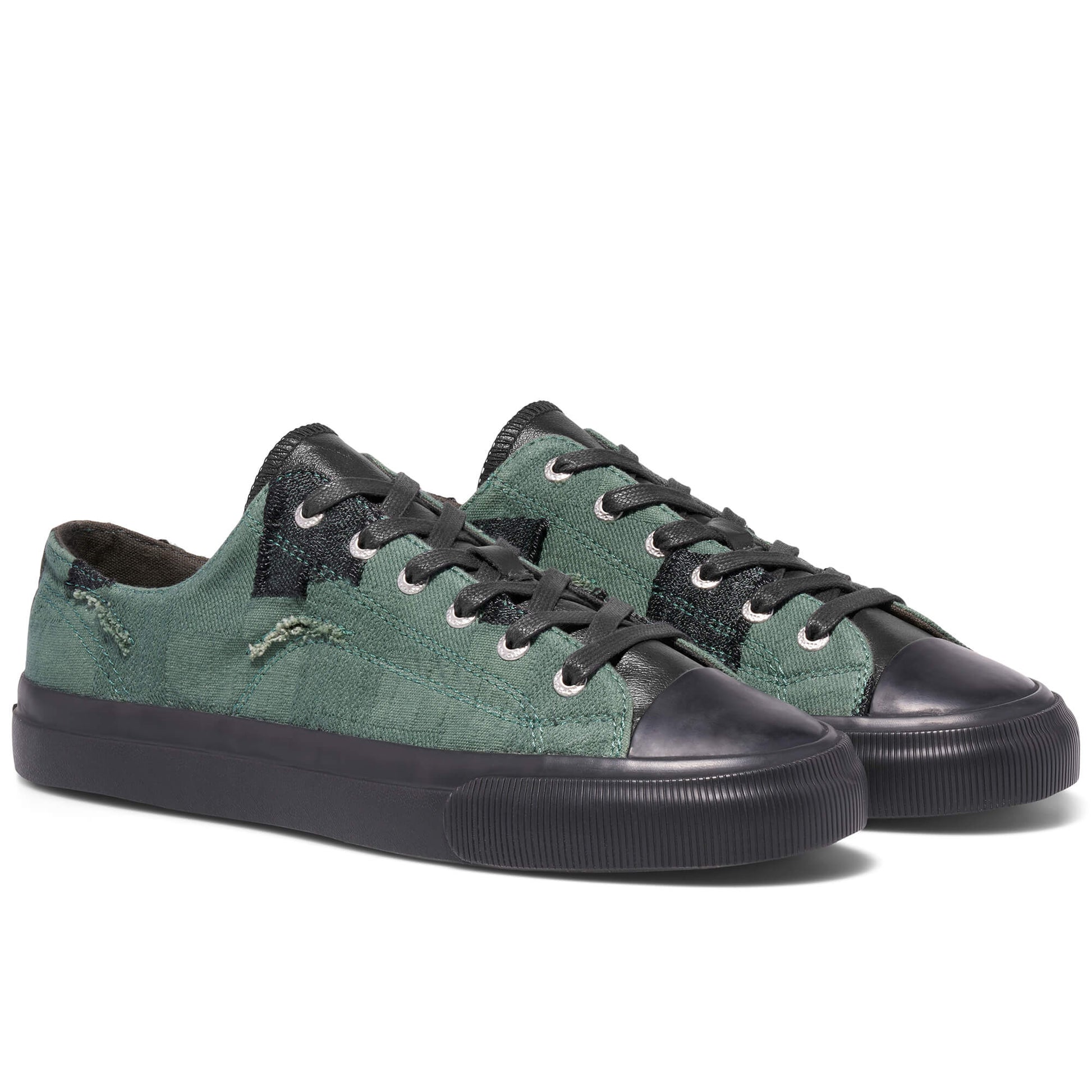 Green sneakers with black soles on a white background