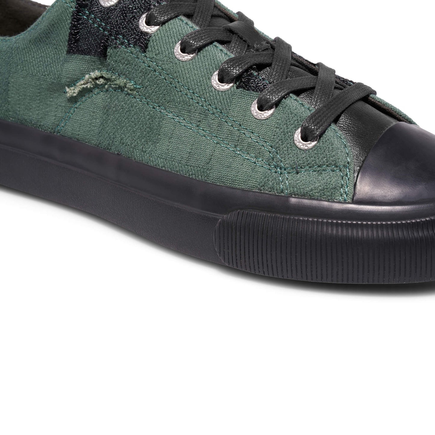 Green sneaker with black accents on a white background