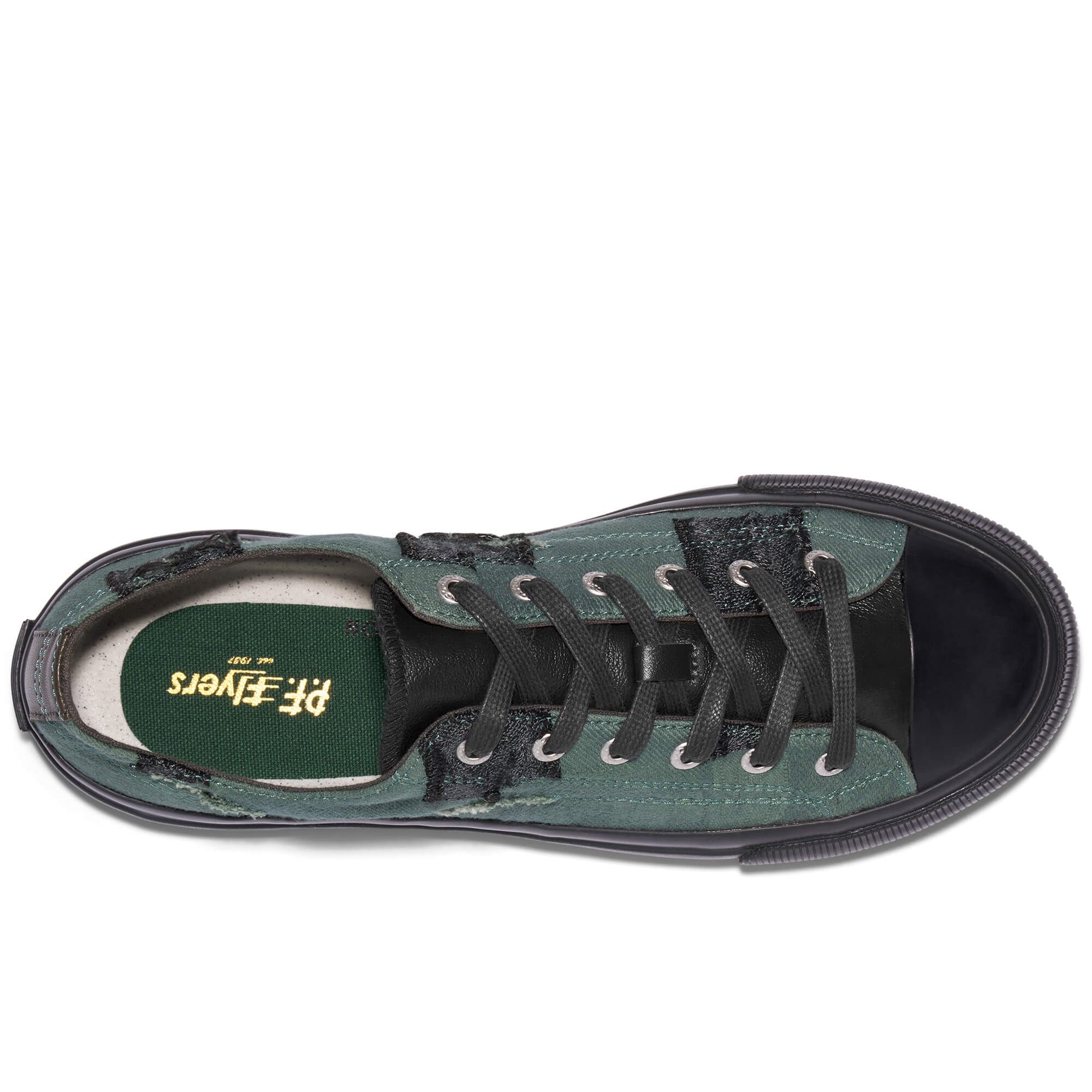 Green sneaker with black laces on a white background