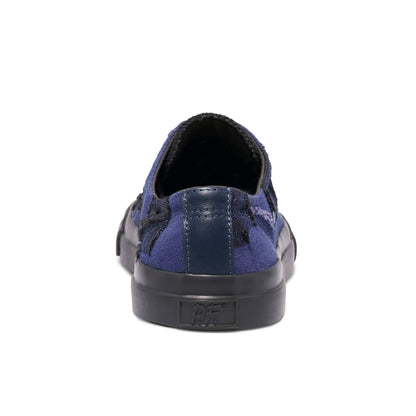 Blue slip-on sneaker with a black sole on a white background