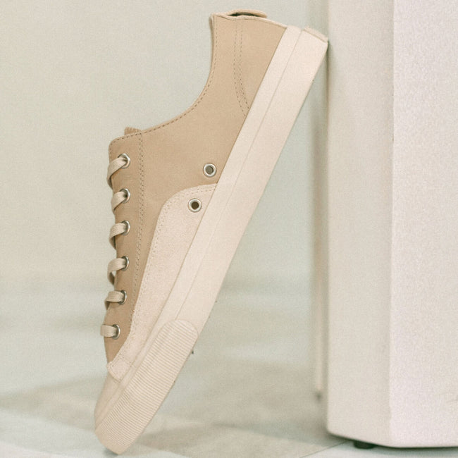 Beige sneaker with white sole on a light gray background
