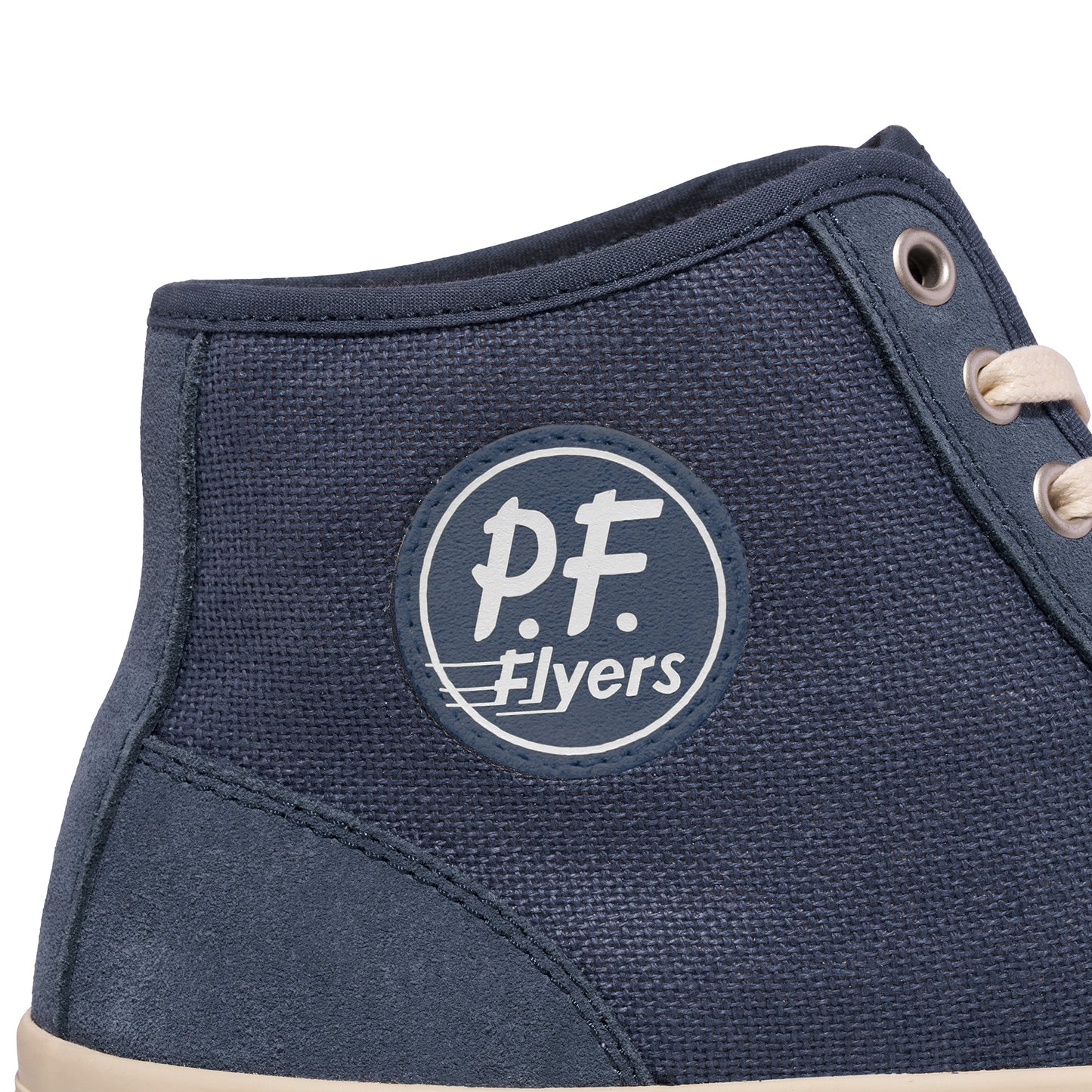 Close-up of a blue P.F. Flyers patch on a high-top sneaker.