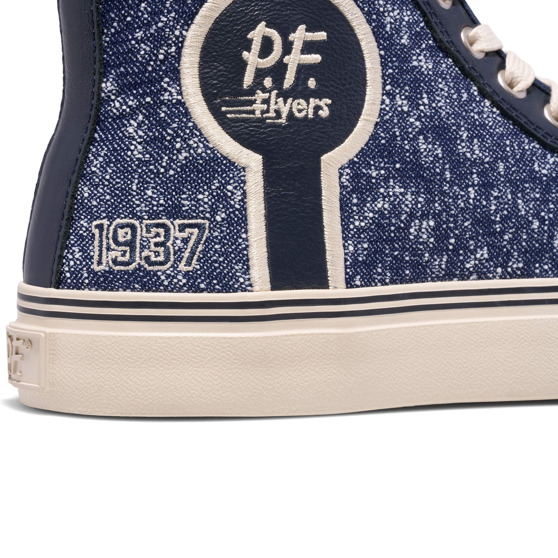 Navy blue glittery sneaker with 'P.F. Flyers' logo and '1937' text on a white background