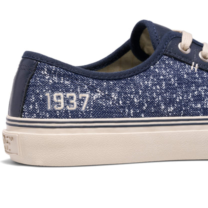 Navy blue glittery sneaker with '1937' text on a white background