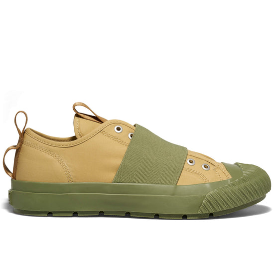 Two-tone sneaker with beige and green color scheme on a white background