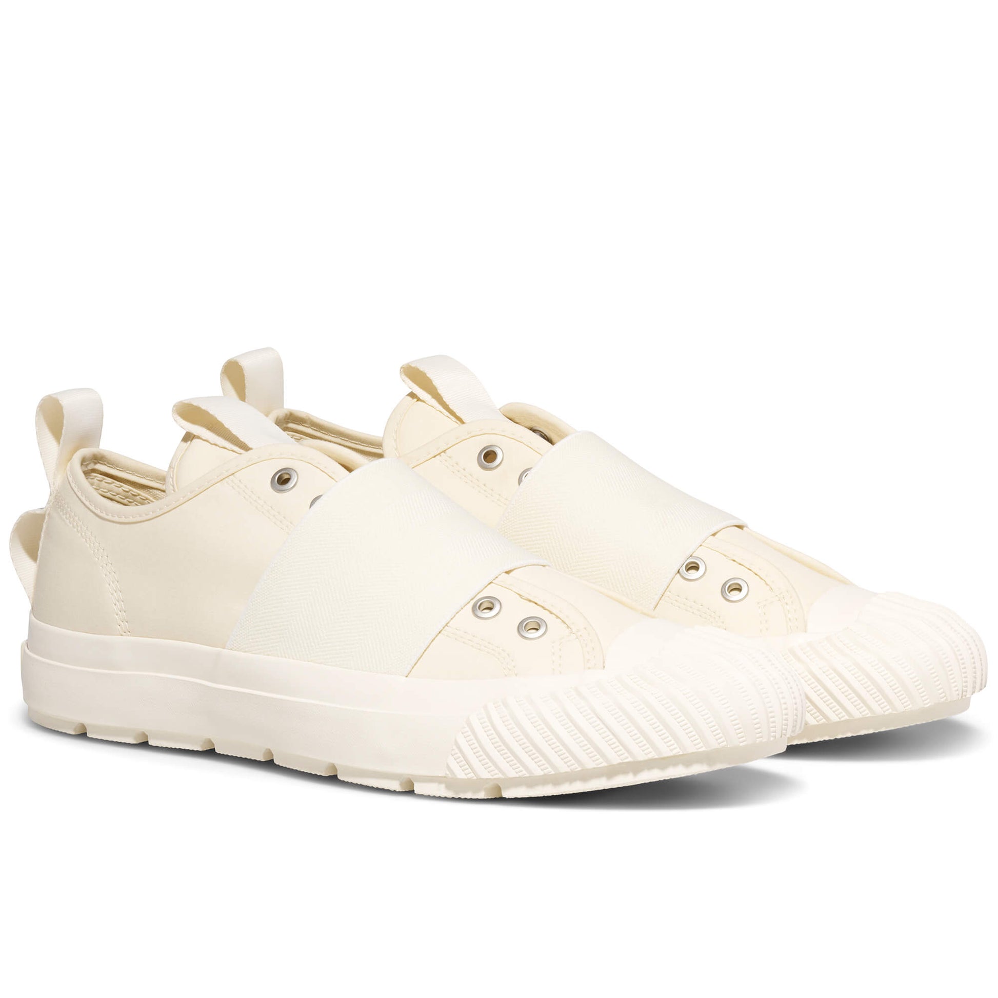 Pair of cream-colored sneakers on a white background
