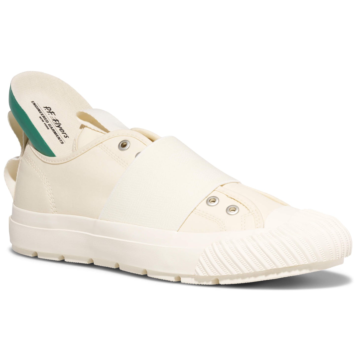 White slip-on shoe with green interior on a white background