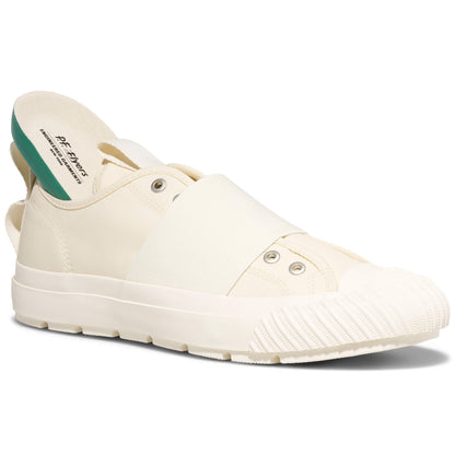 White slip-on shoe with green interior on a white background
