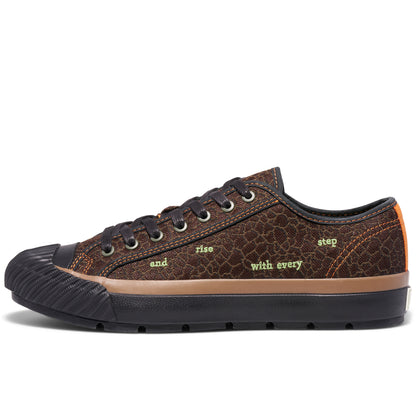 Brown low-top sneaker on a white background, with “and rise with every step” embroidered on the upper.