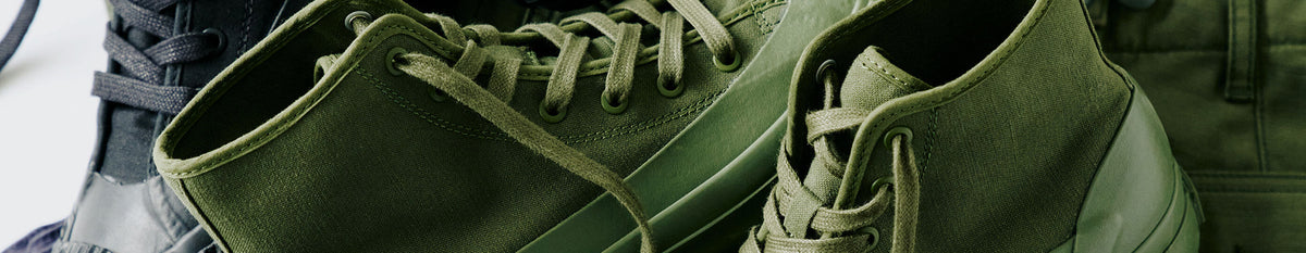Close-up of olive green boots.