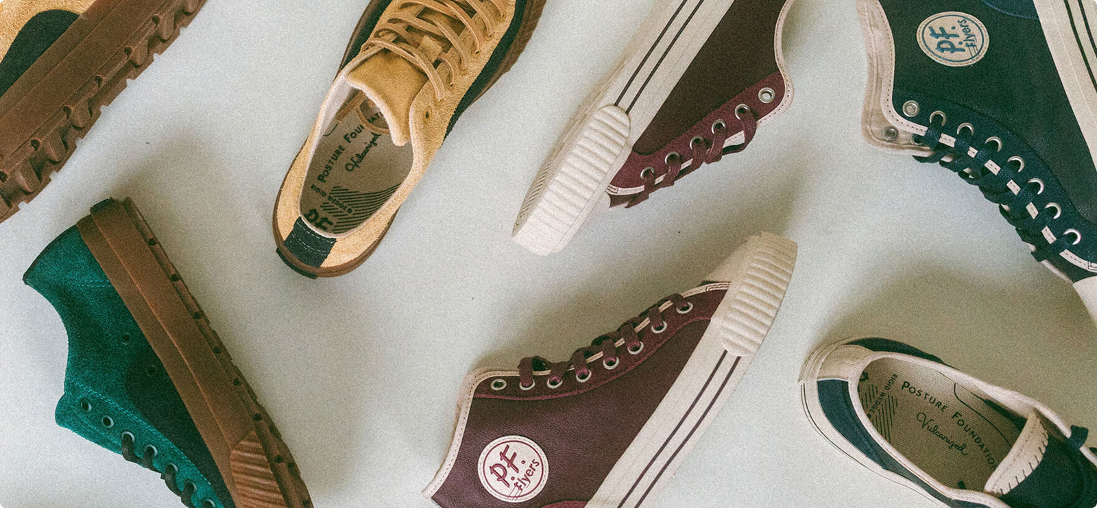 Collection of high-top and low-top leather sneakers on a white background.