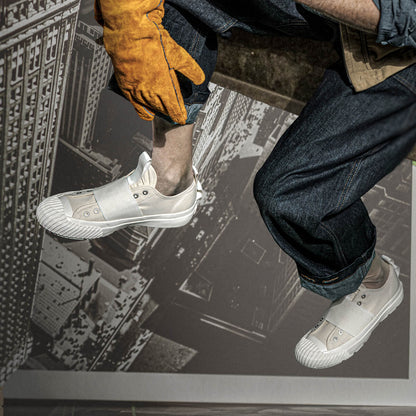 Person wearing white sneakers with a cityscape background