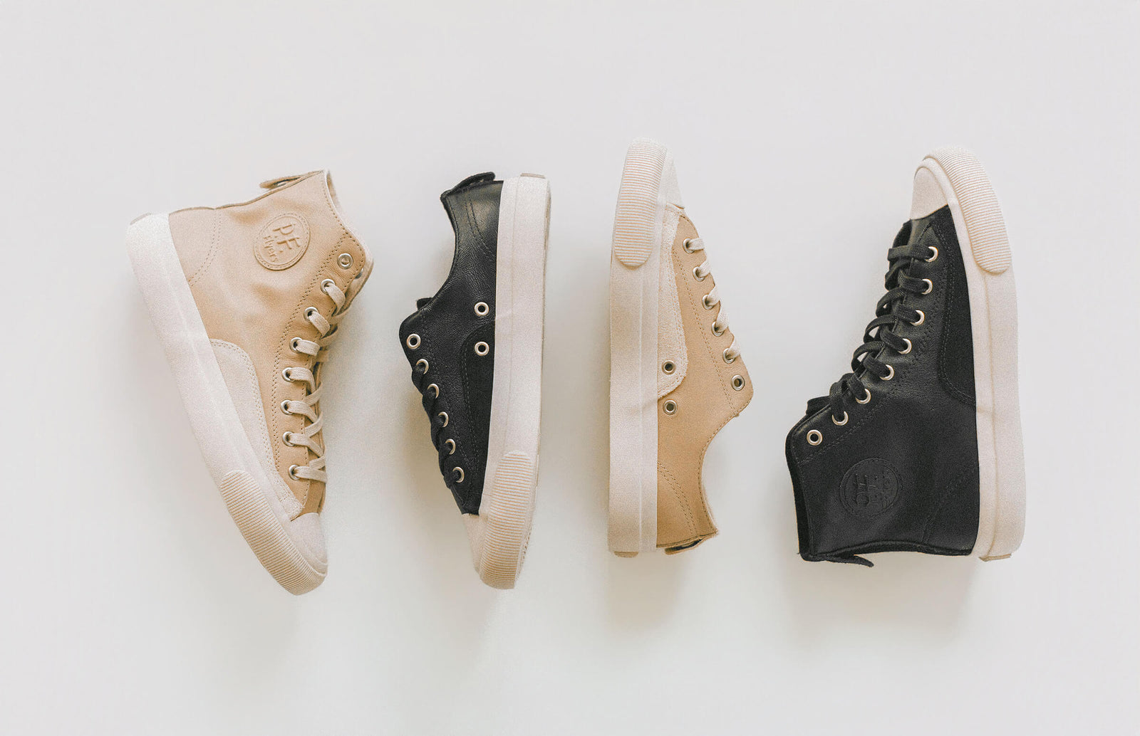 Four pairs of high-top sneakers in black and beige on a white background