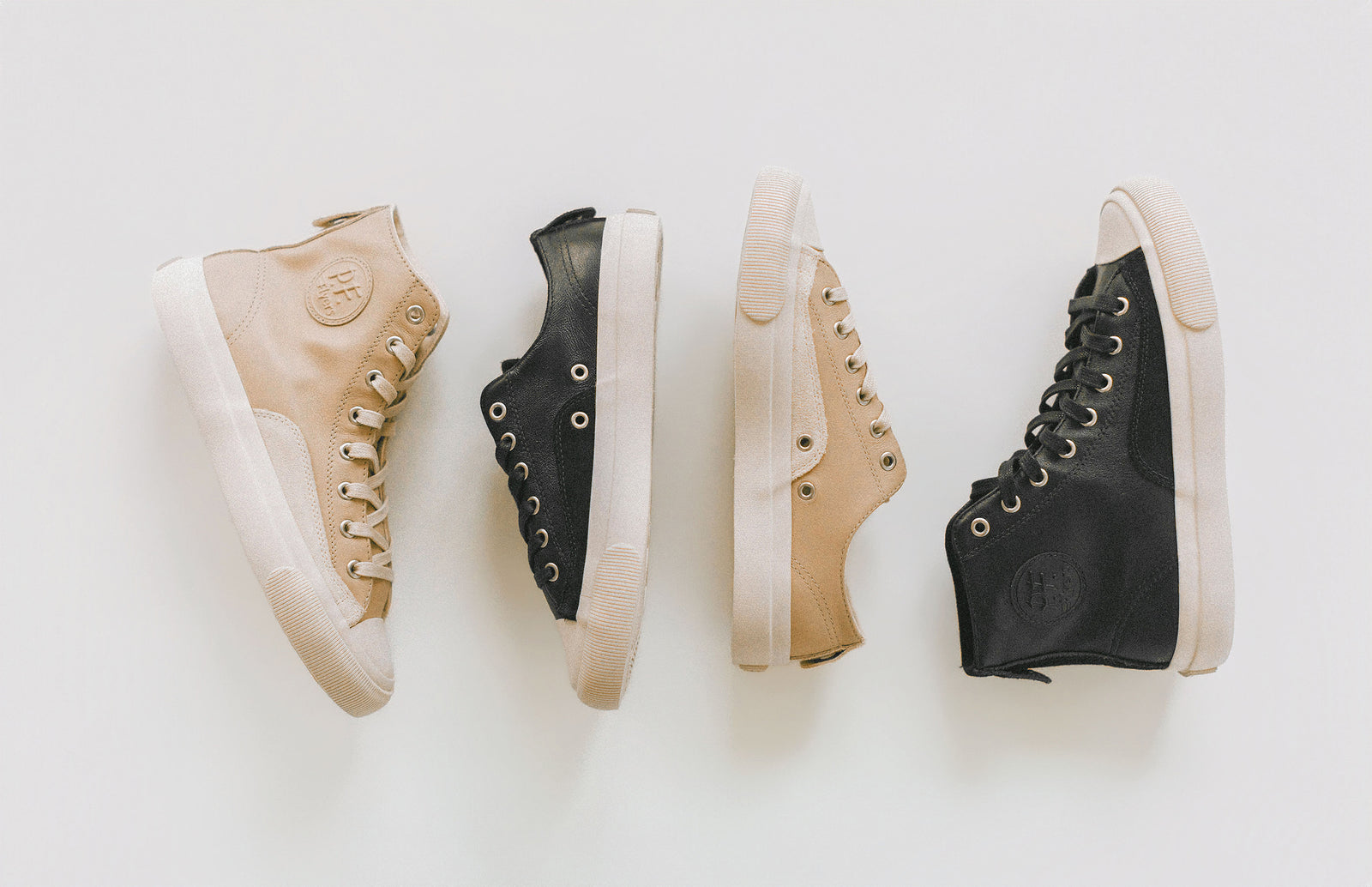 Four pairs of high-top sneakers in black and beige on a white background